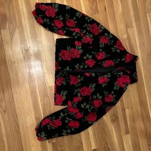 Black jacket with red rose designs, comfortable, good for cold weather.